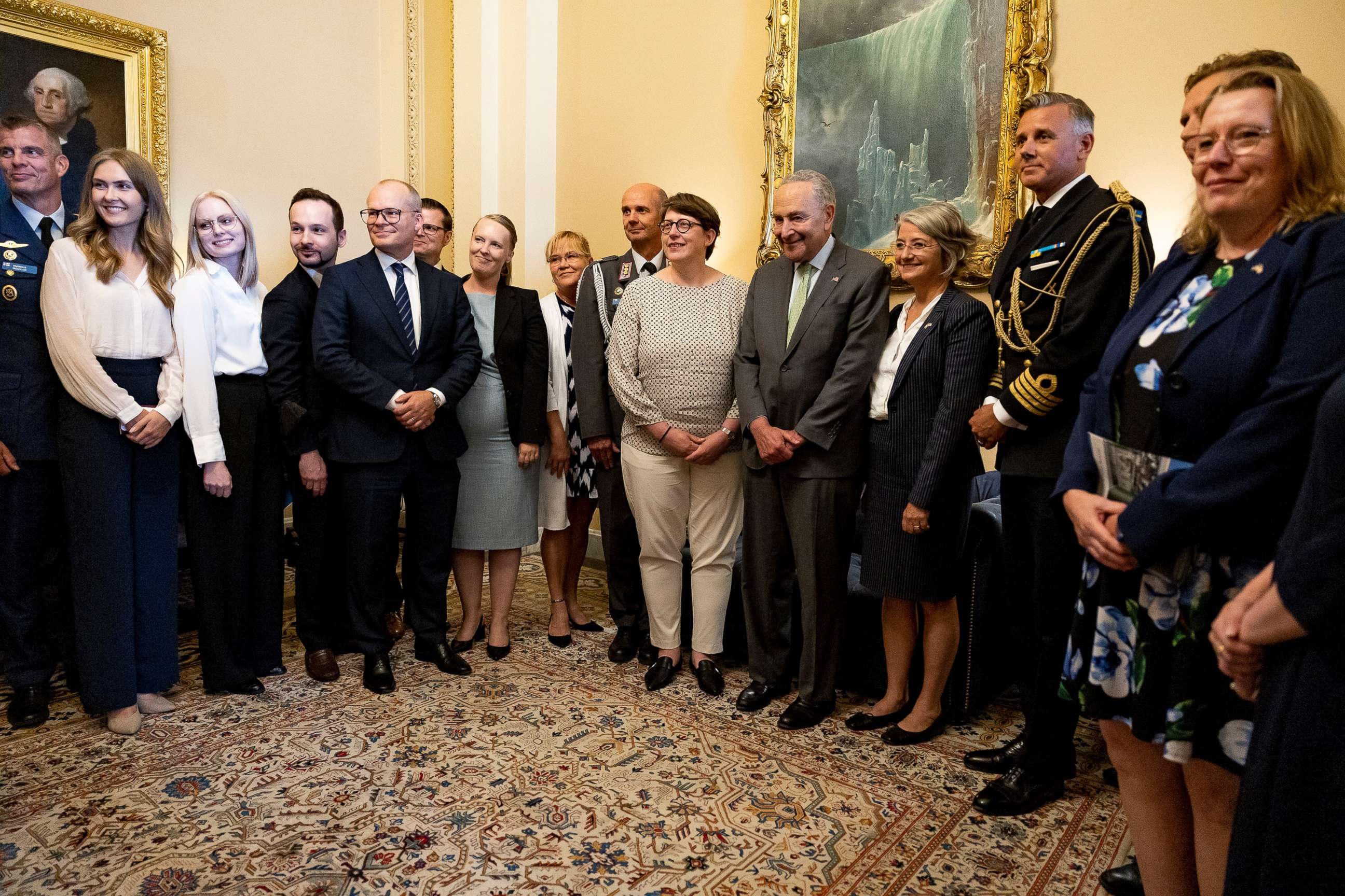PHOTO: Senate Majority Leader Chuck Schumer poses for a photo with an official delegation from Finland and Sweden in his office in Washington, Aug. 3, 2022.