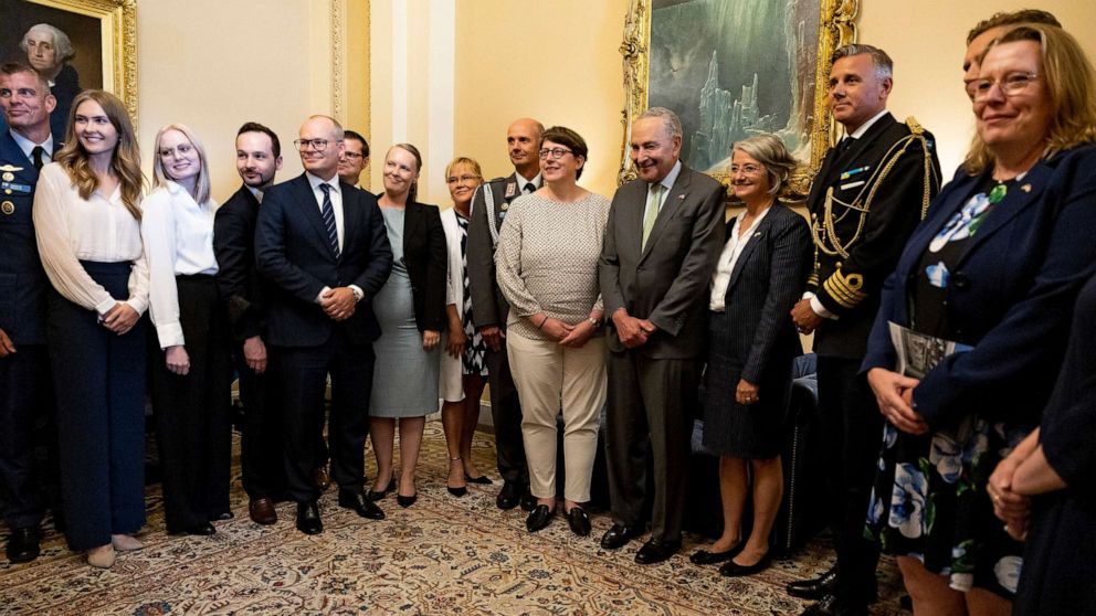 PHOTO: Senate Majority Leader Chuck Schumer poses for a photo with an official delegation from Finland and Sweden in his office in Washington, Aug. 3, 2022.