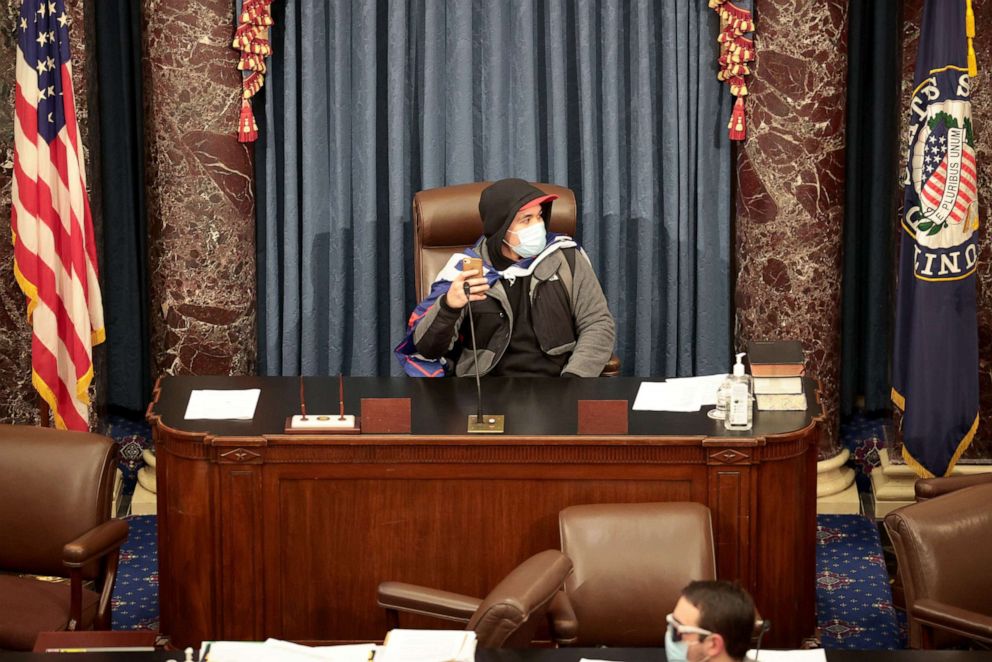 PHOTO: A Trump supporter sits in the Senate Chamber on Jan. 06, 2021, in Washington, D.C.