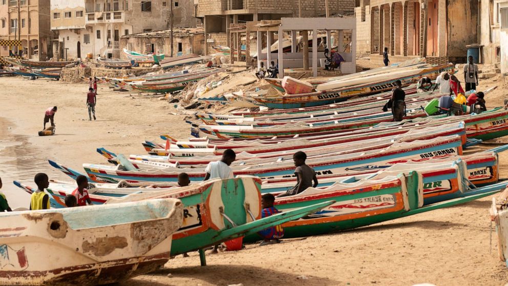 PHOTO: Children play on fishing boats known as a piroguesa in Dakar, Senegal, Saturday June 24, 2023. Large pirogues such as the one found Tuesday, Aug. 15, 2023, near Cabo Verde are used in migrant crossings from Senegal to Spain.