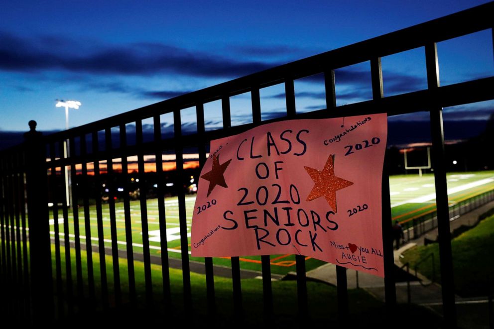 PHOTO: A sign honoring the Paul D. Schreiber Senior High School graduating class of 2020 is seen on a fence as the coronavirus disease (COVID-19) continues, while lights are turned on in tribute, at Whitney Field in Port Washington, New York, May 1, 2020.