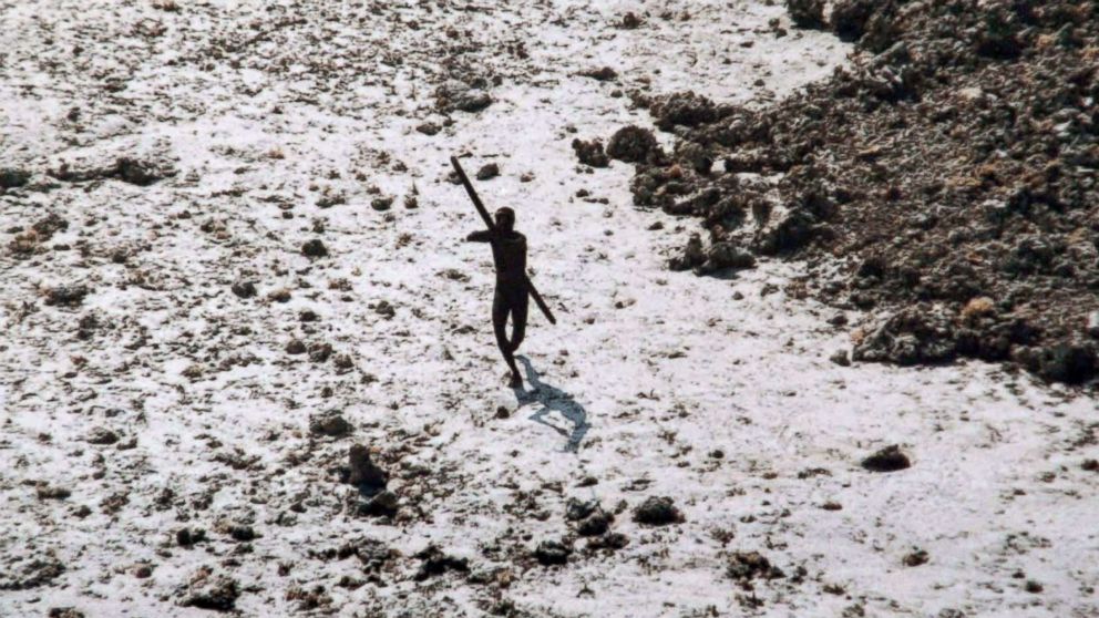 PHOTO: A man with the Sentinelese tribe aims his bow and arrow at an Indian Coast Guard helicopter as it flies over North Sentinel Island in the Andaman Islands, Dec. 28, 2004.
