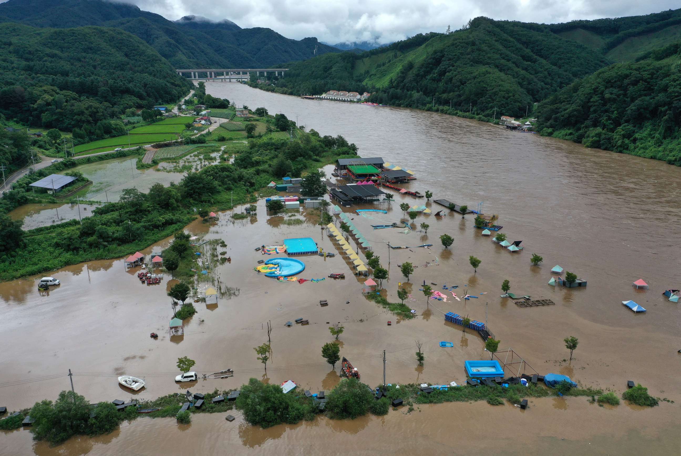 PHOTO: Muddy water floods a swimming area as a nearby river overflowed amid torrential rain, in Chuncheon in Seoul, Aug, 10, 2022.