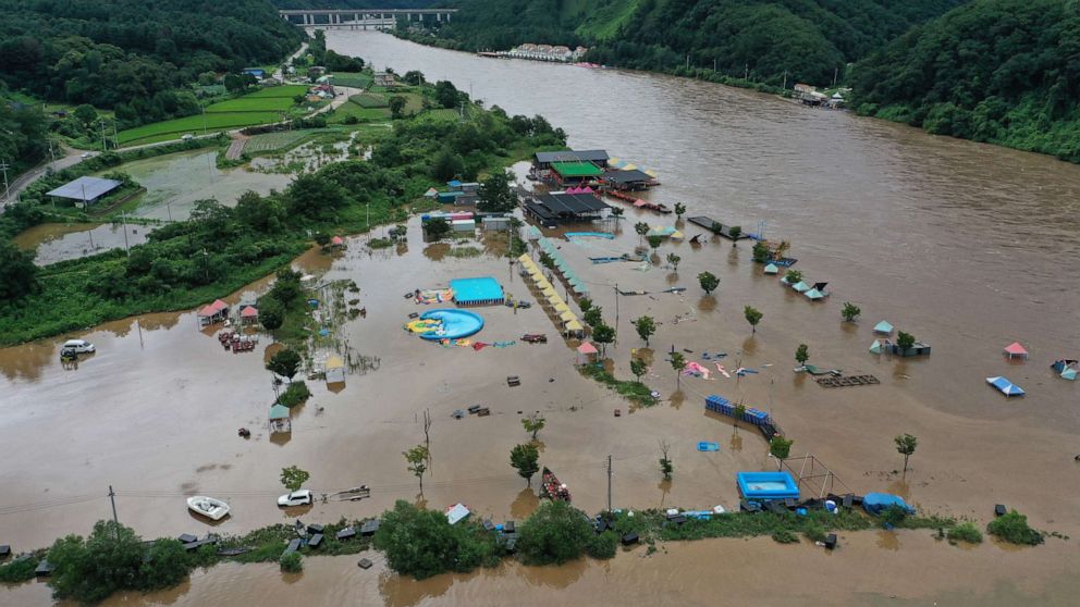 PHOTO: Muddy water floods a swimming area as a nearby river overflowed amid torrential rain, in Chuncheon in Seoul, Aug, 10, 2022.
