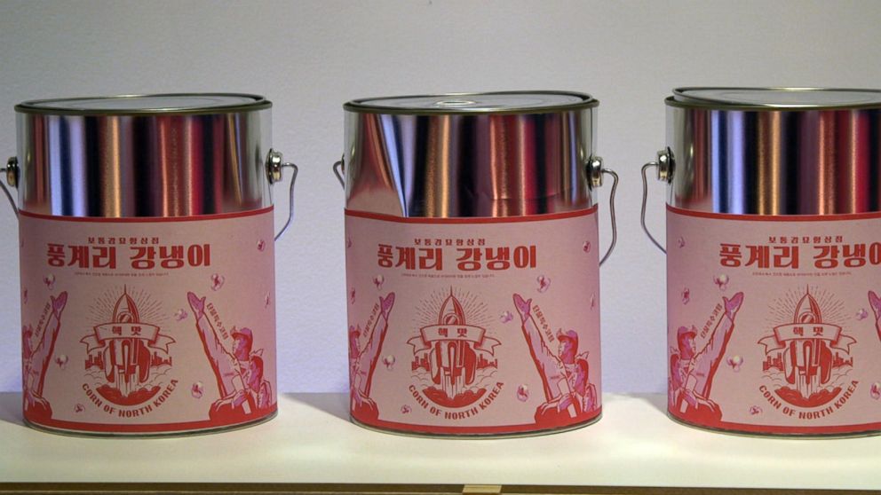 PHOTO: Tin cases covered in pink stickers are filled with "Punggye-ri popcorn," named after a nuclear site in North Korea.