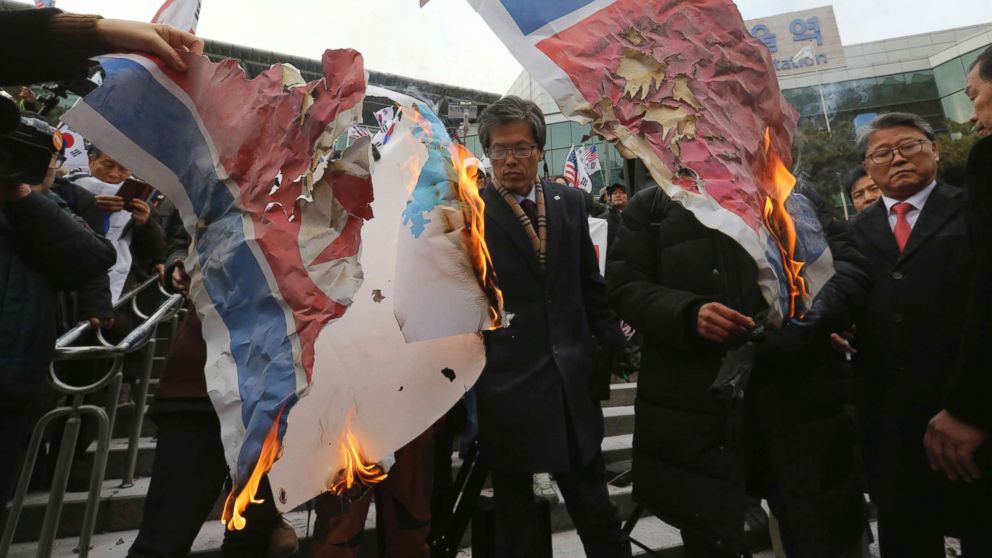 PHOTO: South Korean protesters burn a North Korean and Unification flag during a rally against a visit of North Korean Hyon Song Wol, head of a North Korean art troupe, in front of Seoul Railway Station in Seoul, South Korea, Jan. 22, 2018. 