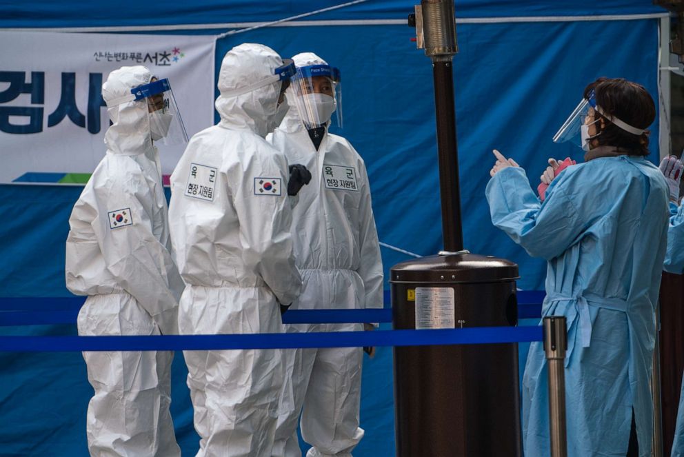 PHOTO: Medical staff dressed in protective suits work at a temporary COVID-19 testing site in Gangnam Station, Seoul, Dec. 26, 2020.