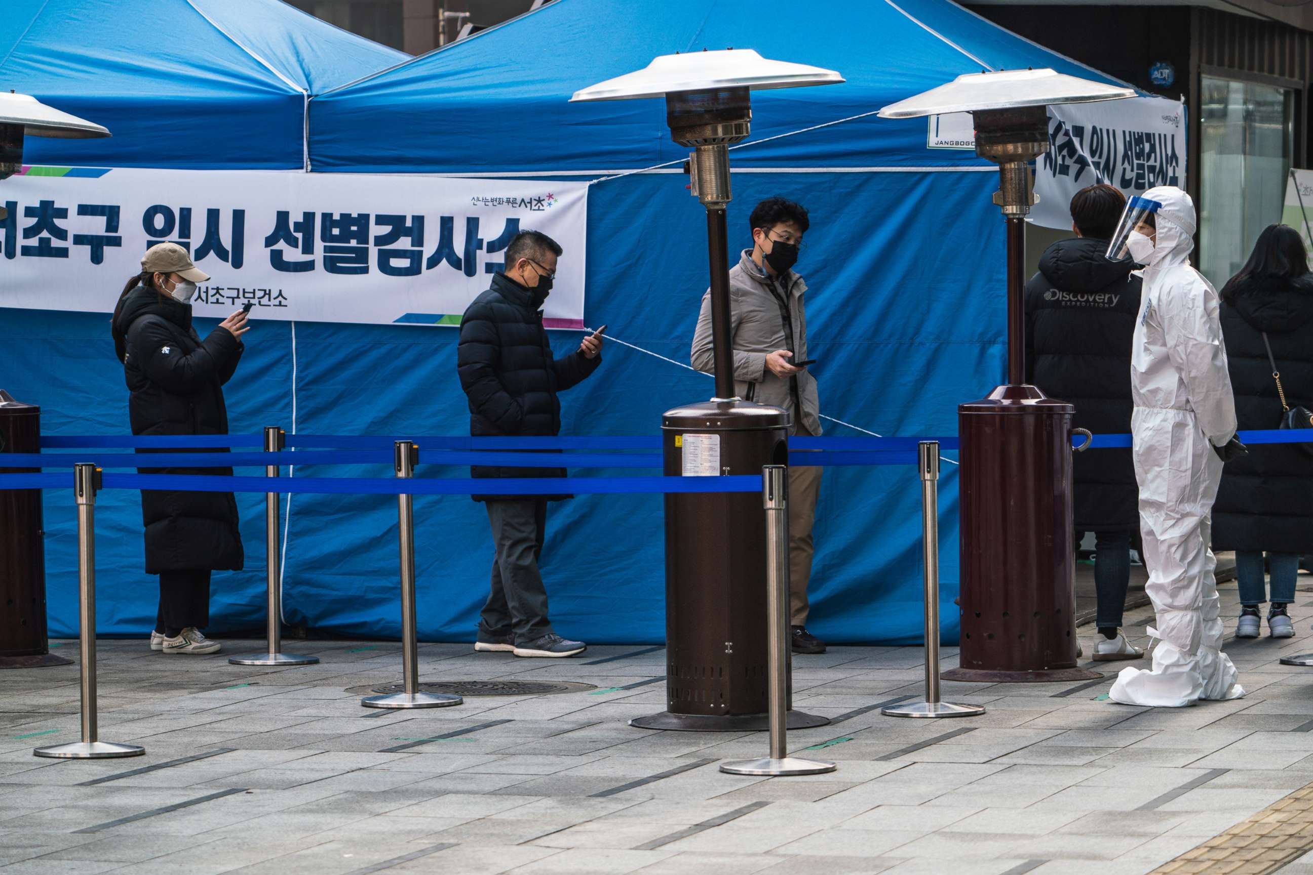 PHOTO: Residents stand in a queue at a temporary COVID-19 testing site in Gangnam Station, Seoul, Dec. 26, 2020.
