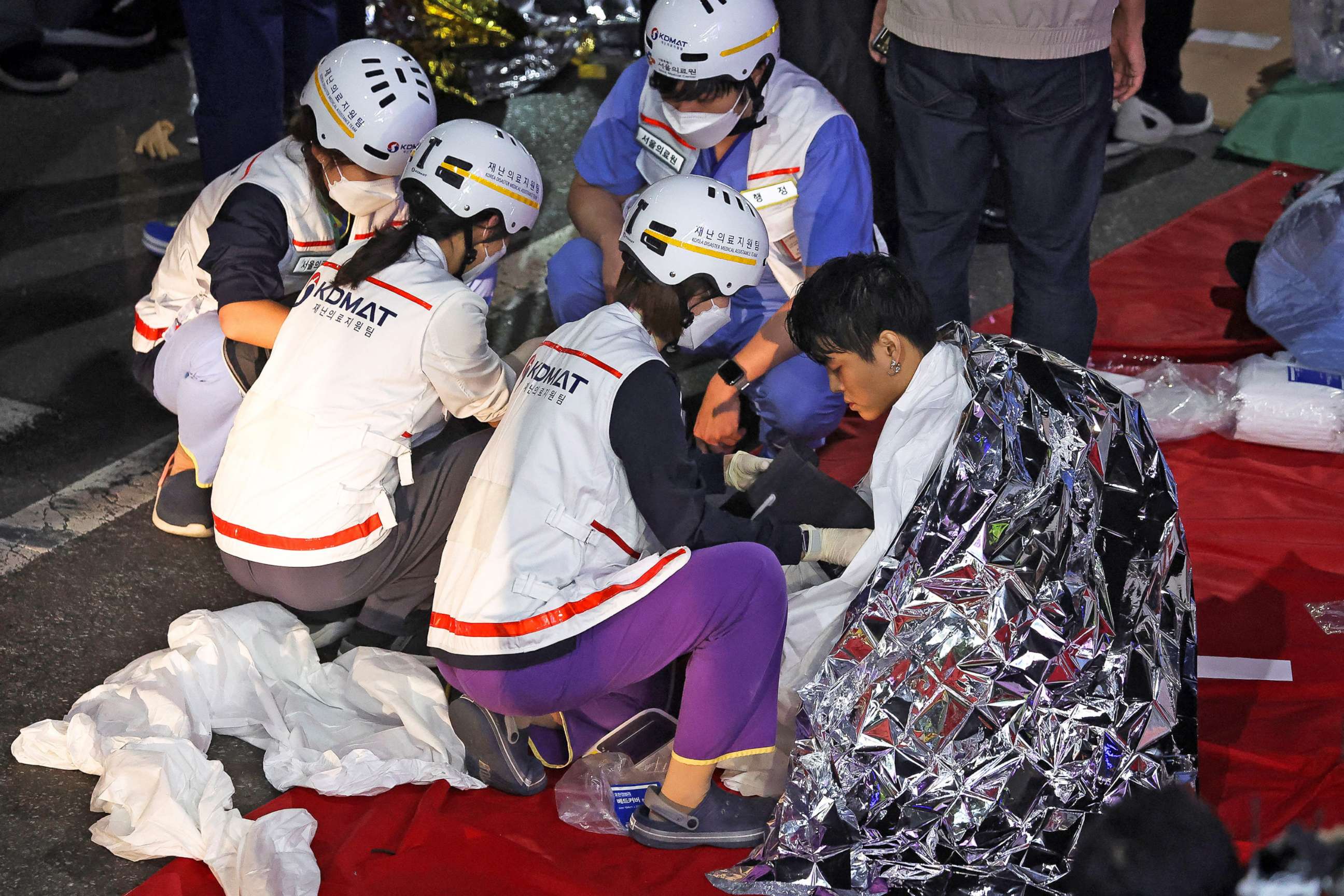 PHOTO: A man receives medical help from rescue team members at the scene where dozens of people were injured in a stampede during a Halloween festival in Seoul,  South Korea, Oct. 30, 2022. 