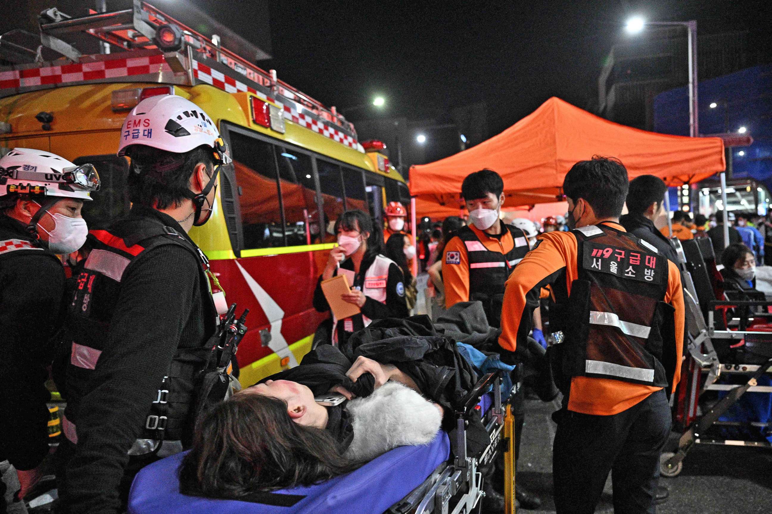 PHOTO: Medical staff attend to a person on a stretcher after dozens were injured in a stampede, after people crowded into narrow streets in the city's Itaewon neighbourhood to celebrate Halloween, in Seoul,  South Korea, on Oct. 30, 2022.