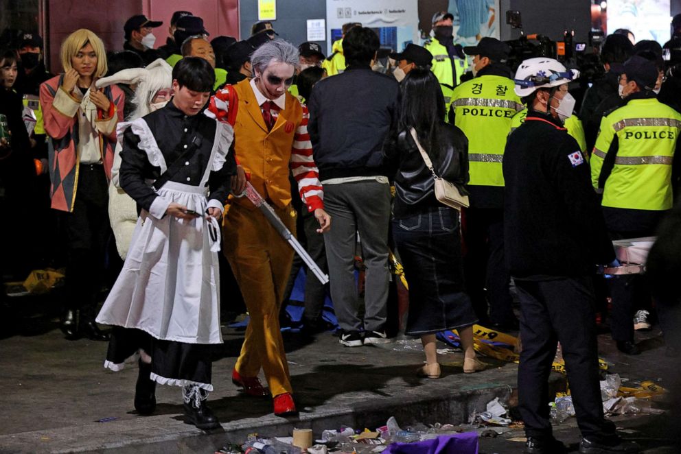 PHOTO: Partygoers leave the the scene where many people died and were injured in a stampede during a Halloween festival in Seoul, South Korea, Oct. 30, 2022.