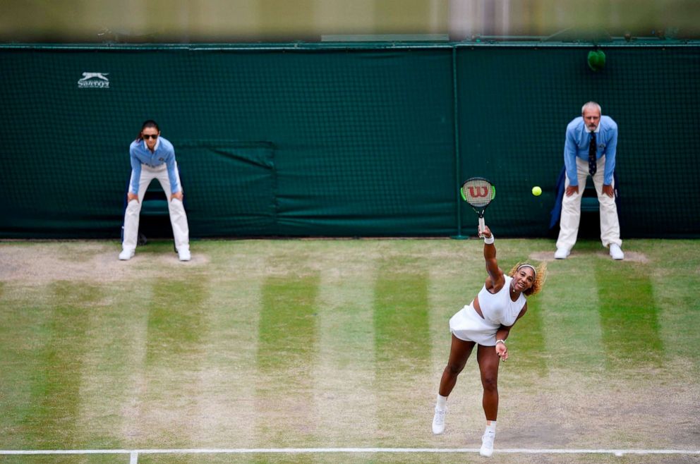 PHOTO: Serena Williams serves to Romania's Simona Halep during their women's singles final on day twelve of the 2019 Wimbledon Championships in Wimbledon, southwest London, July 13, 2019.