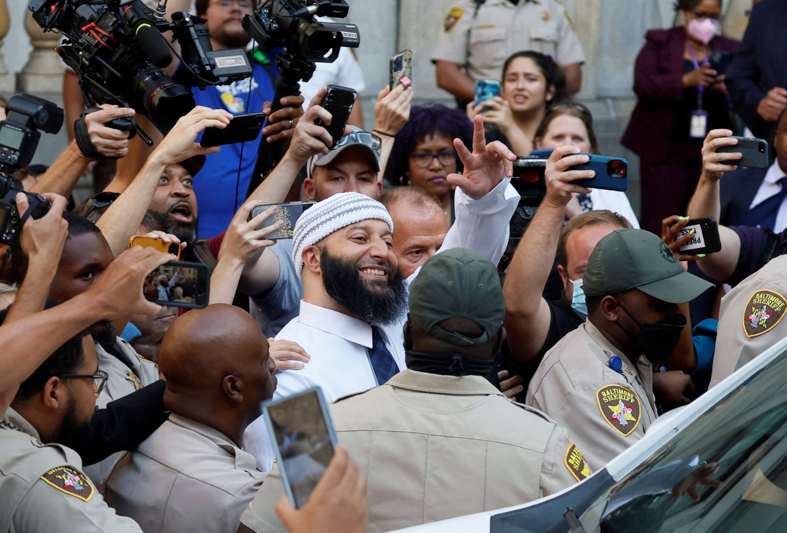 PHOTO: Adnan Syed, whose case was chronicled in the hit podcast "Serial" smiles and waves as he heads to a vehicle after exiting the courthouse after a judge overturned Syed's 2000 murder conviction during a hearing in Baltimore, Sept. 19, 2022.