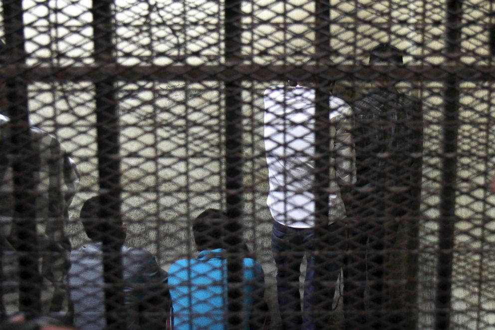PHOTO: Five defendants stand behind bars to hear the ruling on their case for sexual harassment and attacking women during celebrations in June after Egyptian President Abdel Fattah al-Sisi's election, at a court in Cairo, July 16, 2014.