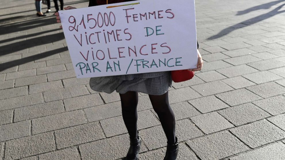 A woman holds a placard reading "21500 women victims of violence per year in France" as people gather for a rally at the Old Port of Marseille, southern France, on Oct. 29, 2017, to denounce harassment and sexual violence in everyday life.