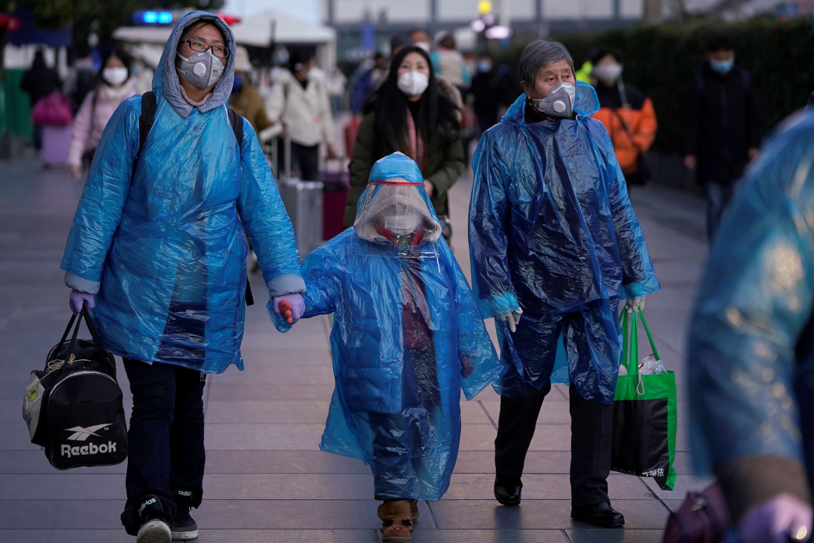 PHOTO: People wear face masks and plastic raincoats as a protection from coronavirus at Shanghai railway station, in Shanghai, China, Feb. 17, 2020.