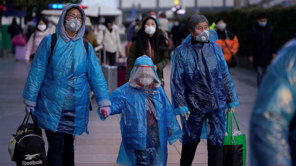 PHOTO: People wear face masks and plastic raincoats as a protection from coronavirus at Shanghai railway station, in Shanghai, China, Feb. 17, 2020.