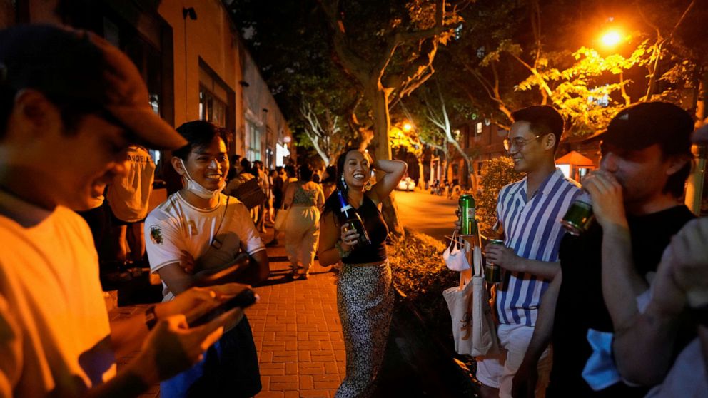 PHOTO: People drink on a street, as the city prepares to end the lockdown placed to curb the coronavirus disease outbreak in Shanghai, China, May 31, 2022.