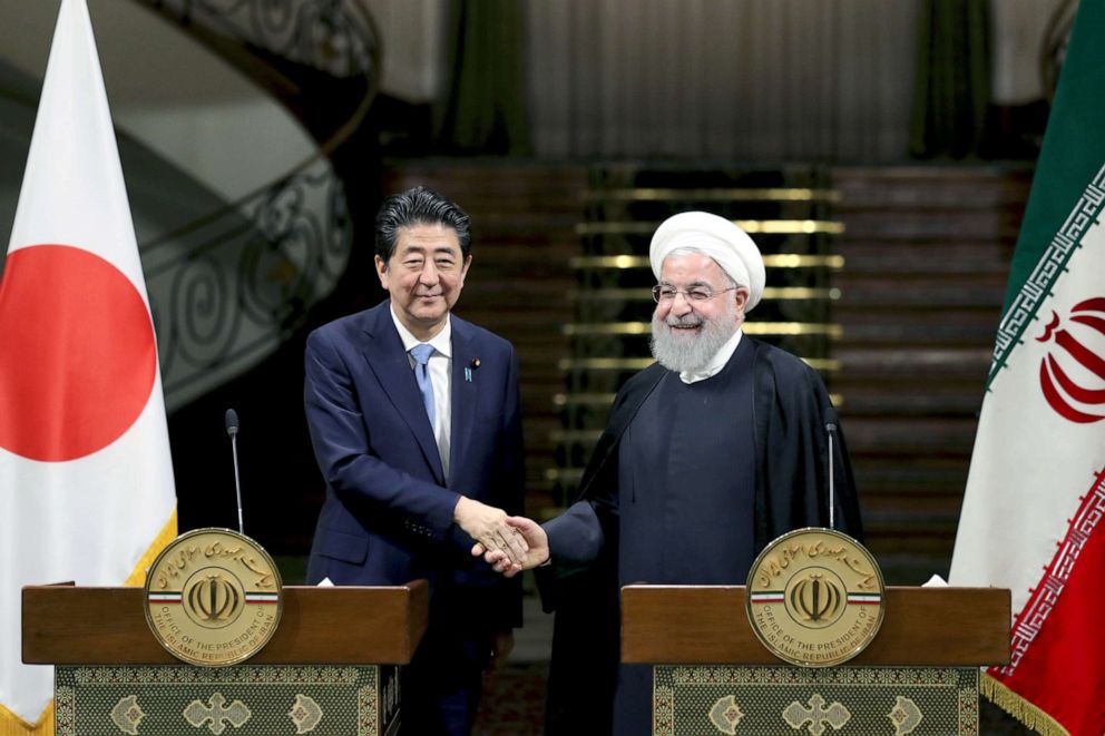 PHOTO: Japanese Prime Minister Shinzo Abe, left, and Iranian President Hassan Rouhani shake hands after their joint press conference at the Saadabad Palace in Tehran, Iran, June 12, 2019. 