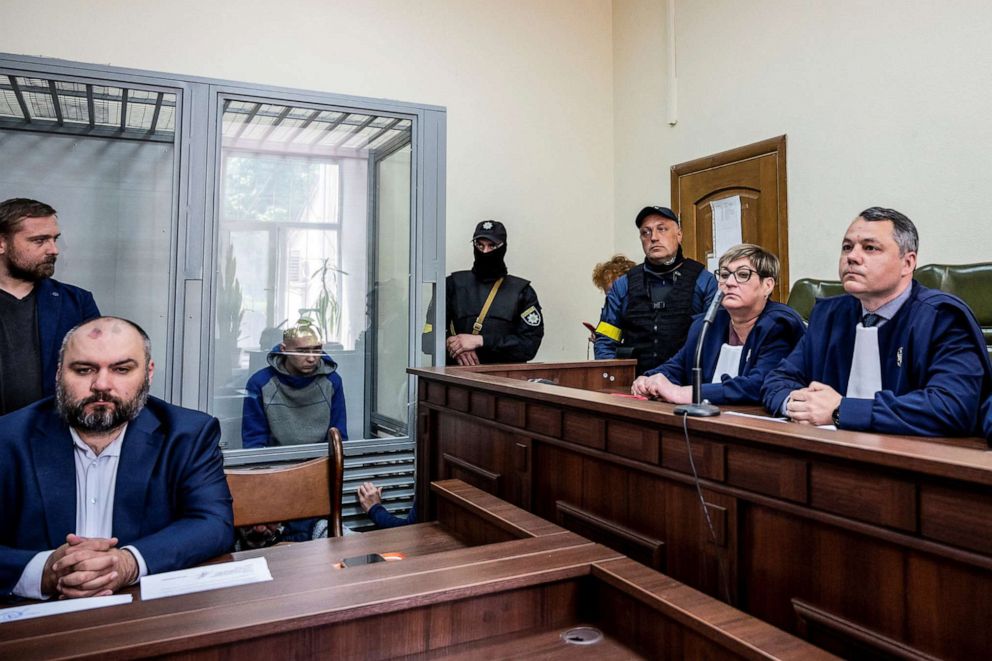 PHOTO: Russian soldier Vadim Shishimarin, 21, accused of violations of the laws and norms of war, sits inside a defendants' cage during a court hearing in Kyiv, Ukraine, May 13, 2022.