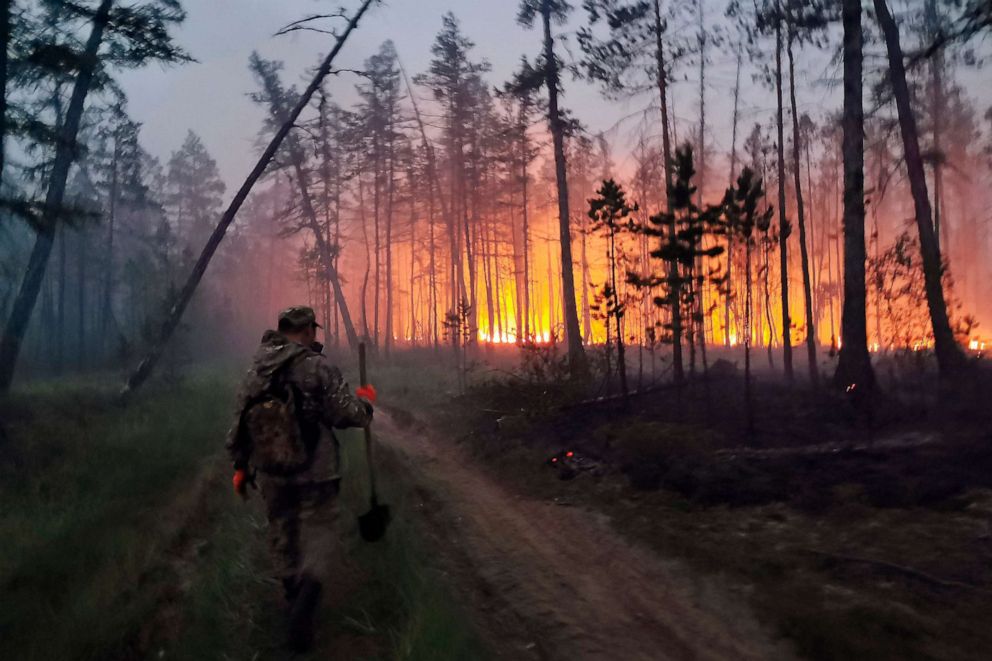 PHOTO: A volunteer heads to douse a forest fire in the republic of Sakha also known as Yakutia, Russia, July 17, 2021.
