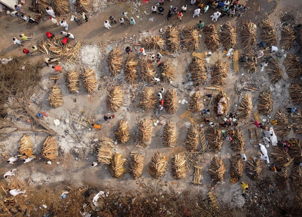 PHOTO: Victims of COVID-10 are prepared for mass cremation in New Delhi, April 28, 2021.