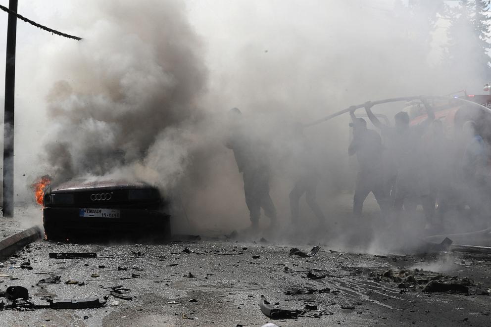 PHOTO: Lebanese firefighters put out a fire in a car after an Israeli strike in the southern city of Sidon on Aug. 21, 2024.