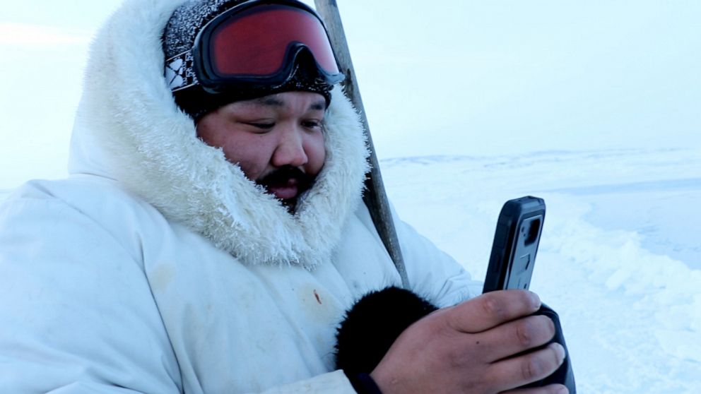 PHOTO: Puasi Ippak tests out the SIKU mobile app near Sanikiluaq.