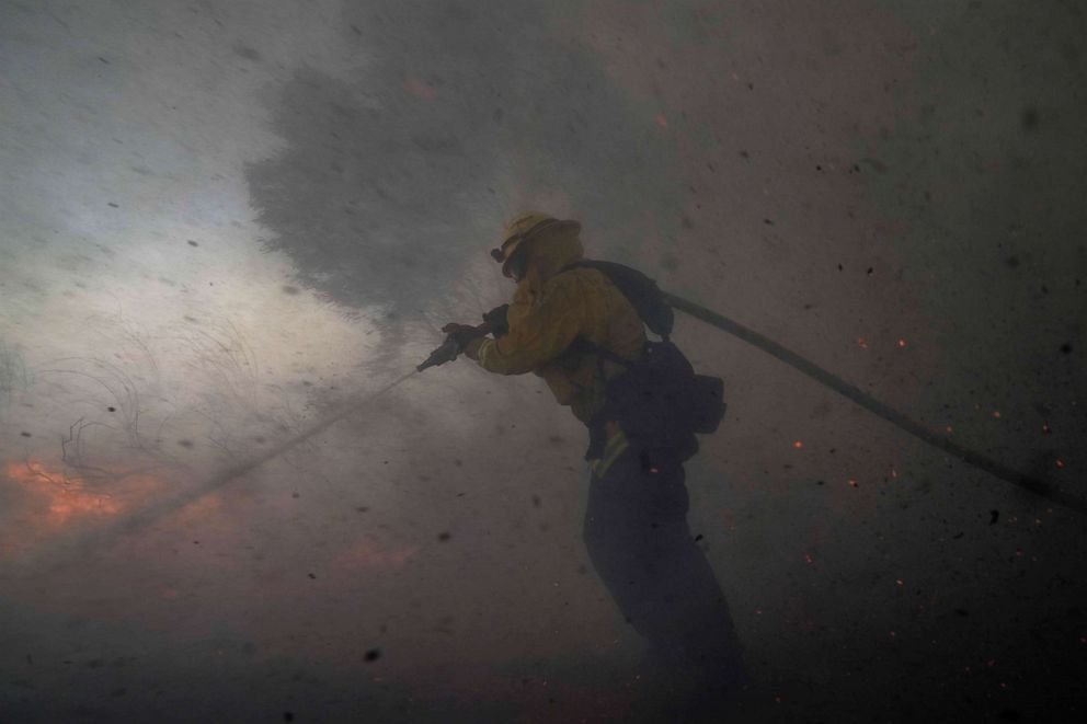 PHOTO: A firefighter battles the Silverado Fire Monday, Oct. 26, 2020, in Irvine, Calif.