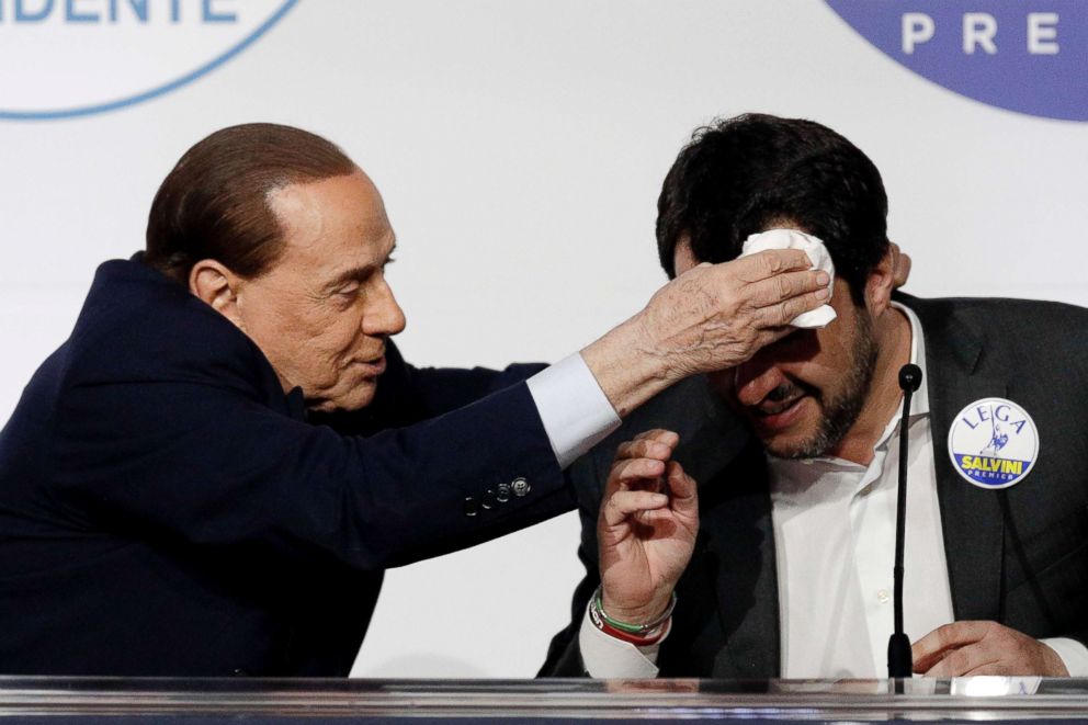 PHOTO: Forza Italia's Silvio Berlusconi whipes the forehead of League's Matteo Salvini at a media event for center-right leaders ahead of the March 4 general elections, in Rome, March 1, 2018. 