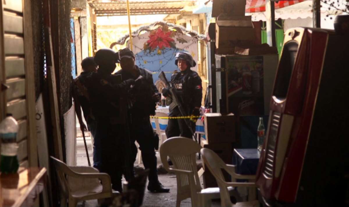 PHOTO: Mexican authorities access a homicide scene in Acapulco where a food stand owner was shot and killed. 