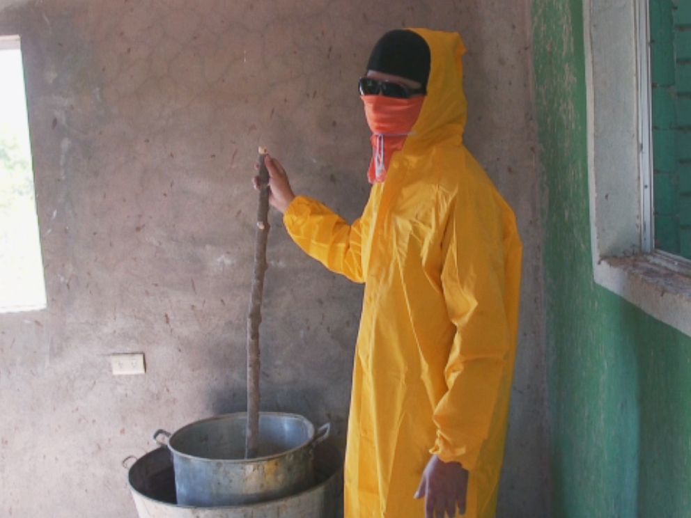 PHOTO: One of the Sinaloa cartels freelance cooks demonstrates how he turns the gum from the poppy flower into heroin.