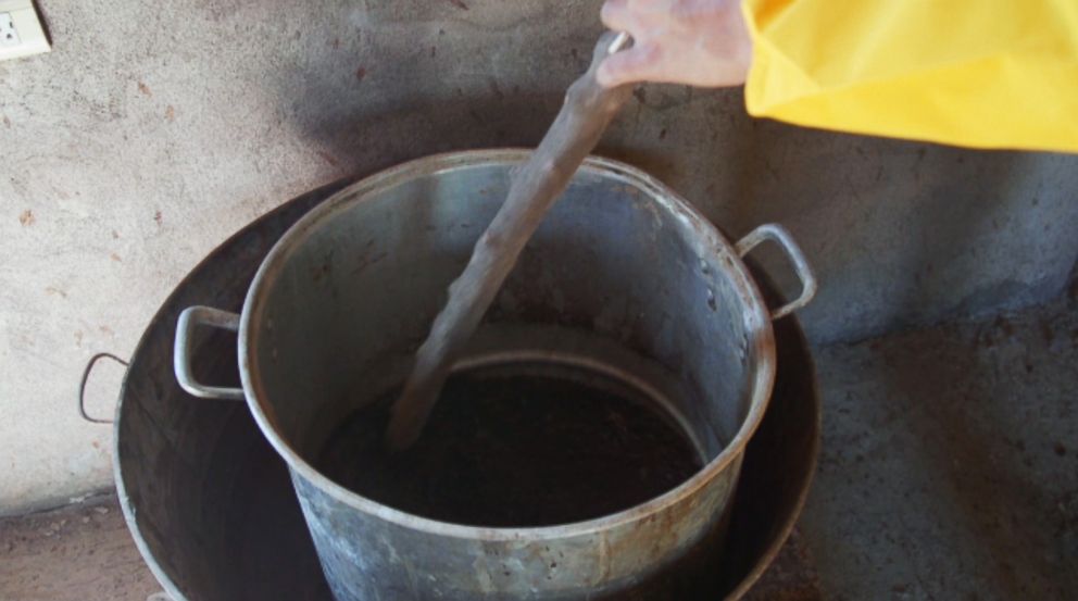 PHOTO: One of the Sinaloa cartel's freelance cooks uses a standard metal pot to cook the poppy gum.