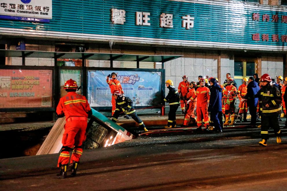 PHOTO: Rescuers prepare to lift a bus after a road collapse in Xining in China.