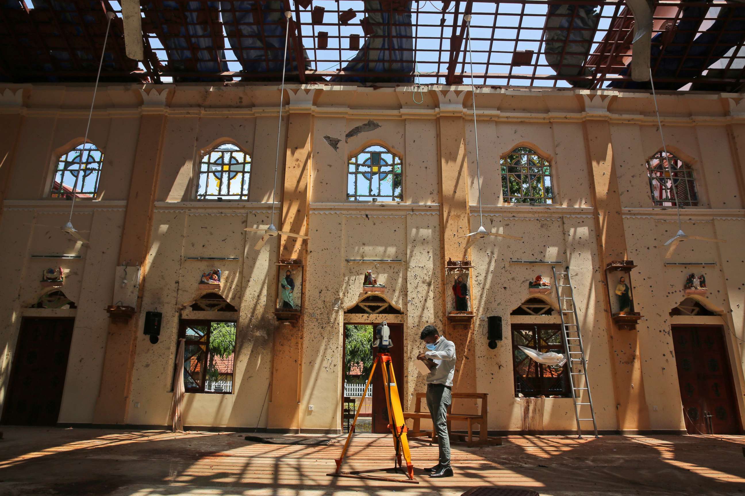 PHOTO: Sunlight steams in from gaping holes, as a surveyor works at St. Sebastian's Church, where a suicide bomber blew himself up on Easter Sunday in Negombo, north of Colombo, Sri Lanka, April 25, 2019.