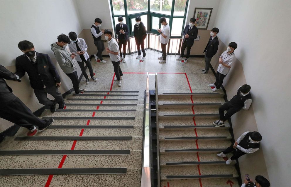 PHOTO:High school students wearing protective masks stand in line to enter the cafeteria, as schools reopen following the global outbreak of the coronavirus disease (COVID-19), in Seoul, May 20, 2020.  