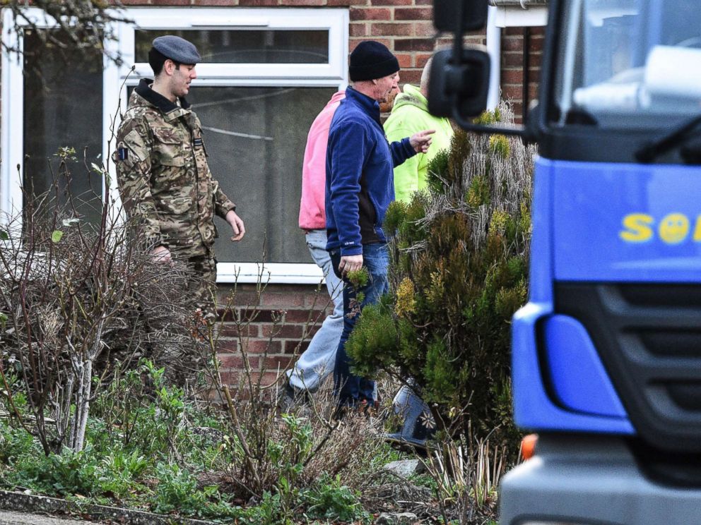 PHOTO: Contractors and military personnel seen outside the home of former Russian spy Sergei Skripal in Salisbury, England, as scaffolding is delivered, Jan. 8, 2019.