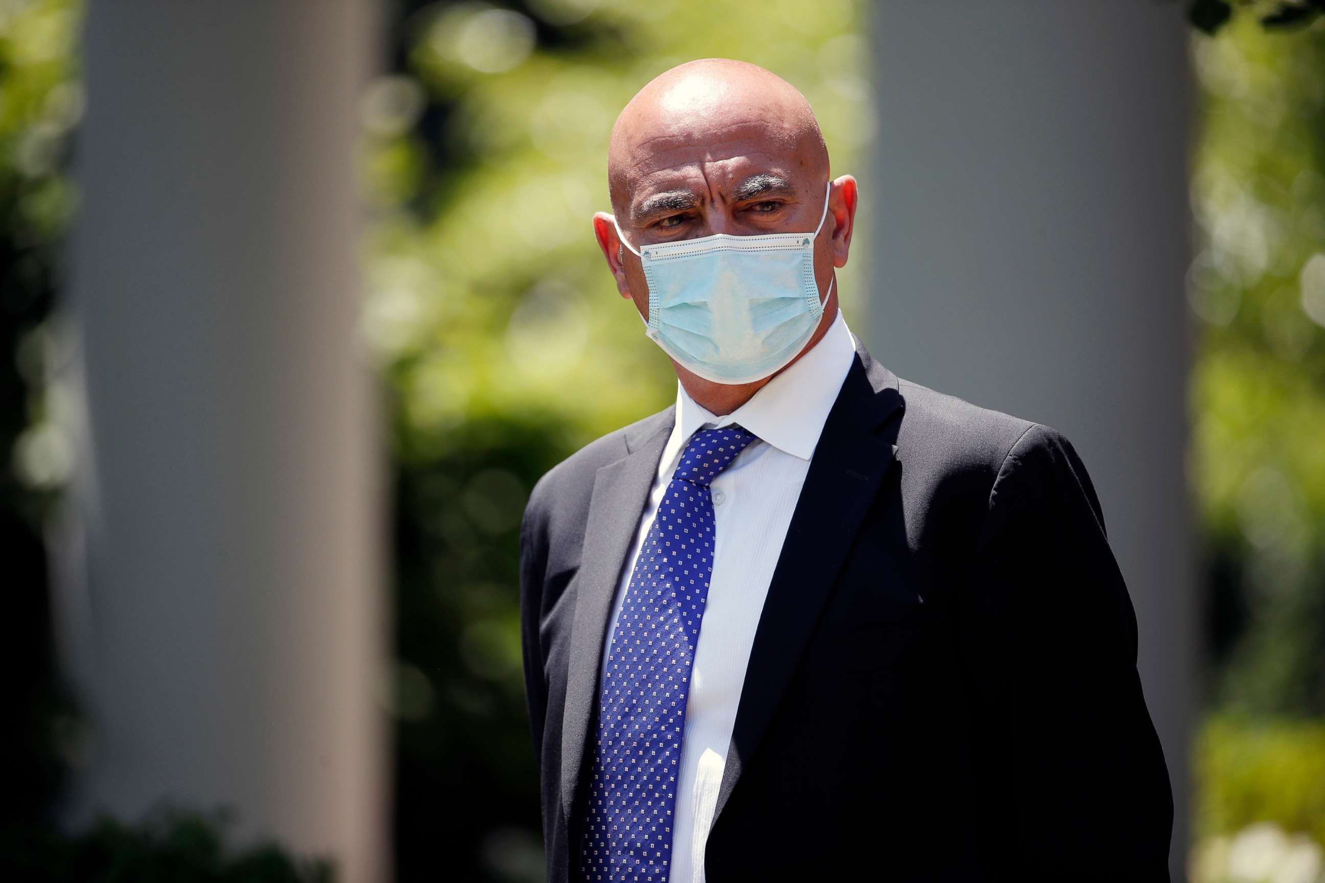 PHOTO: Moncef Slaoui, a former GlaxoSmithKline executive, listens as President Donald Trump speaks about the coronavirus vaccine development in the Rose Garden of the White House, May 15, 2020, in Washington.