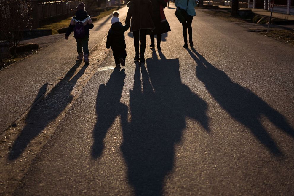 PHOTO: Refugees fleeing Ukraine walk to the reception centre at the Velke Slemence border crossing on March 13, 2022, in Velke Slemence, Slovakia.