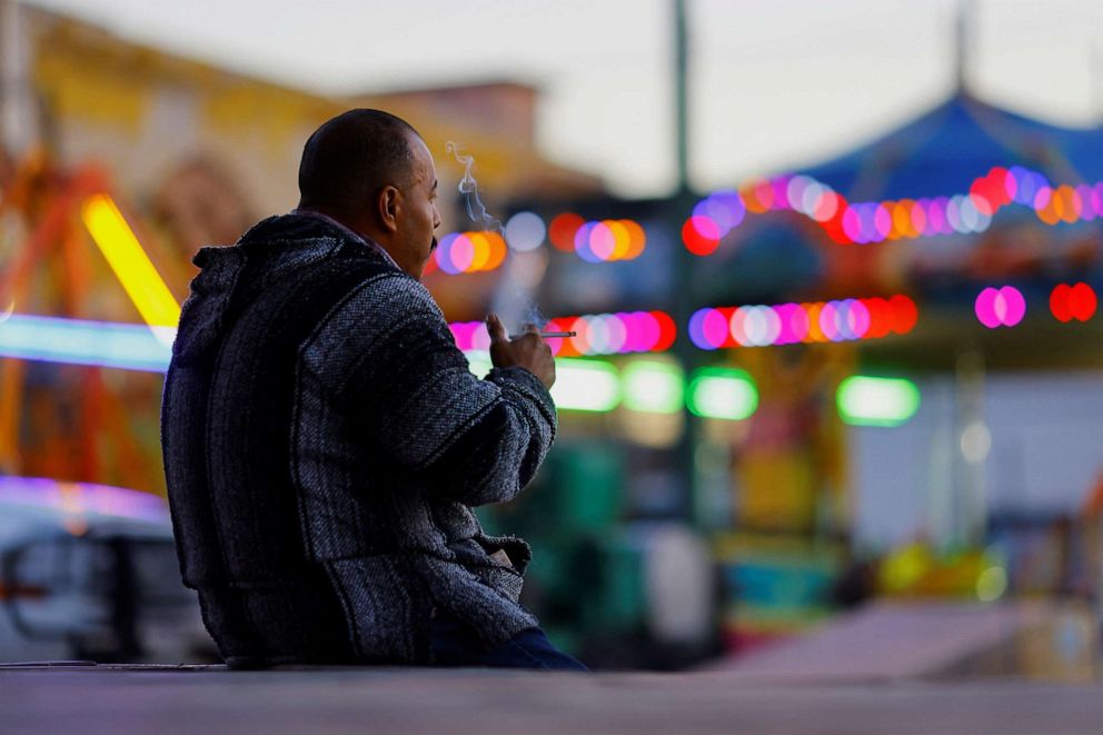 PHOTO: A man smokes in a public plaza, before smoking in public spaces is prohibited according to a reform by the Mexican Government to the country's Regulation of the General Law for Tobacco Control, in downtown Ciudad Juarez, Mexico Jan. 13, 2023.