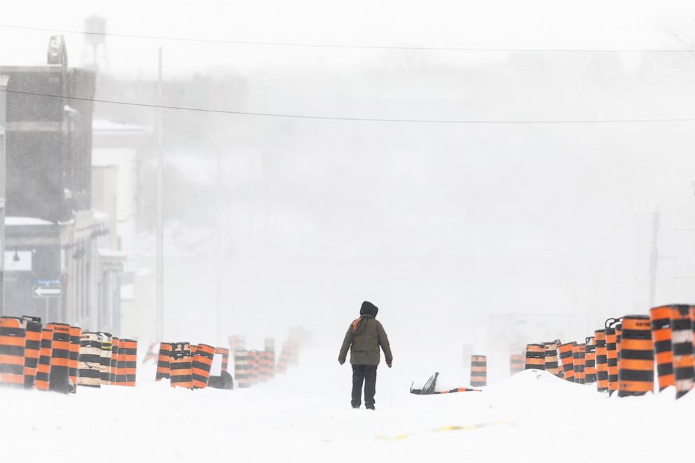 PHOTO: A man walks down the street in Fort Erie, Ontario, Canada, during an early winter storm that delivered high winds and large amounts of snow across southern Ontario and western New York, Nov. 19, 2022. 