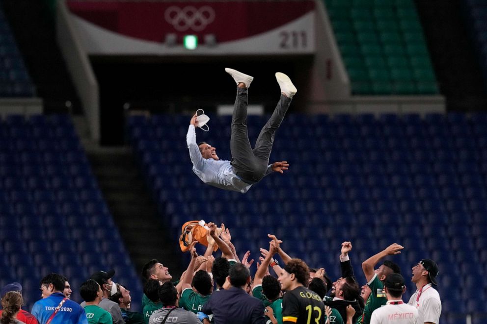PHOTO: Mexico's players celebrate with their coach Jaime Lozano, above, after winning 3-1 to Japan during the men's bronze medal soccer match at the 2020 Summer Olympics, Aug. 6, 2021, in Saitama, Japan.