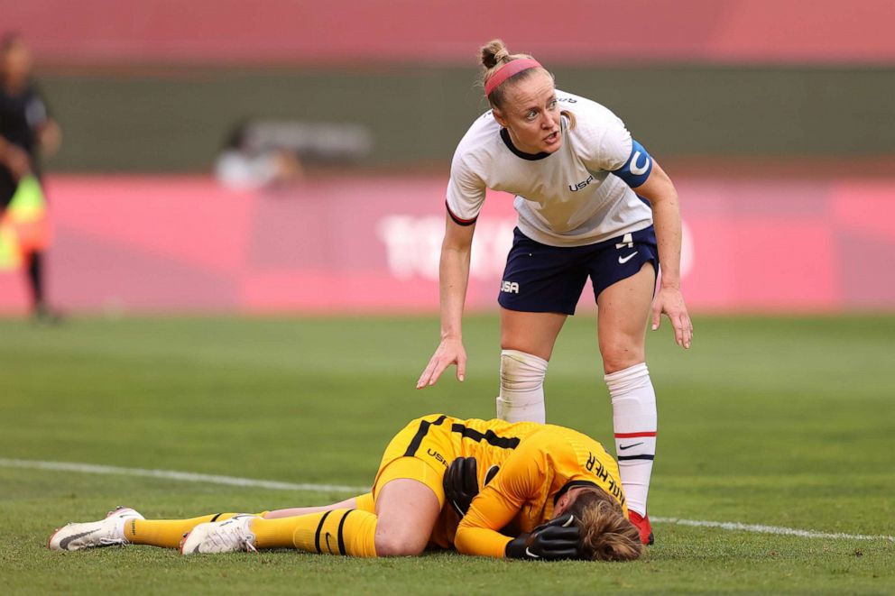 PHOTO: Alyssa Naeher of Team United States lies injured as Becky Sauerbrunn checks on her during the Women's Semi-Final match between USA and Canada at Kashima Stadium on August 2, 2021, in Kashima, Ibaraki, Japan.