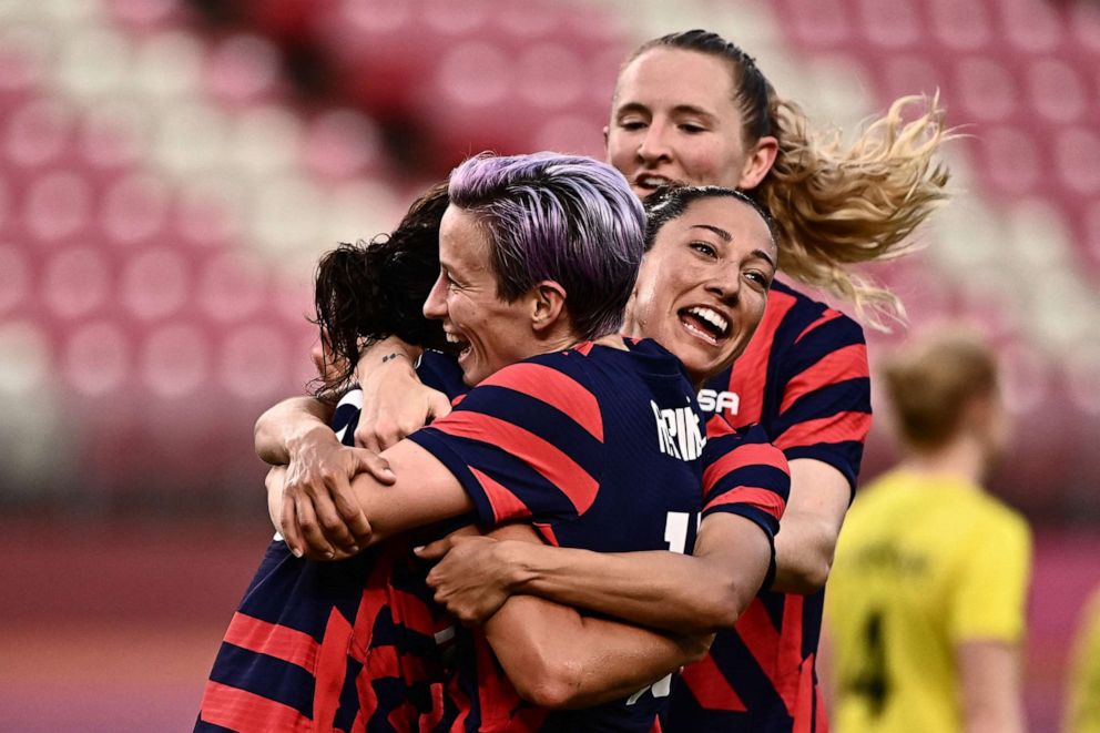 PHOTO: USA's forward Carli Lloyd is congratulated by teammates after scoring during the Tokyo 2020 Olympic Games women's bronze medal football match between Australia and the United States at Ibaraki Kashima Stadium in Kashima city on Aug. 5, 2021.