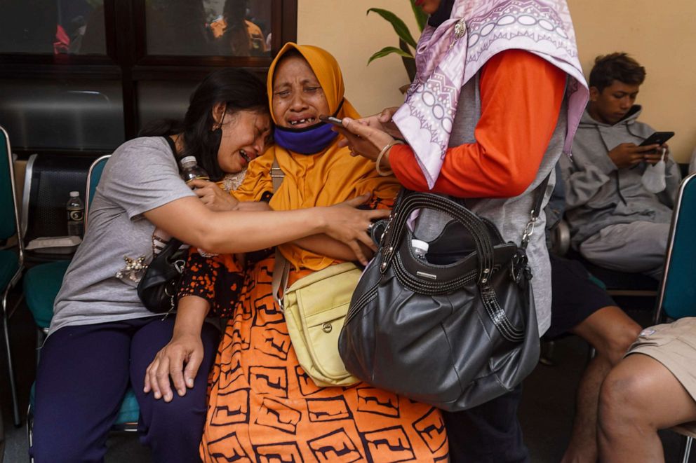 PHOTO: Women weep after receiving confirmation that their family member is among those killed in a soccer riots, at a hospital in Malang, East Java, Indonesia, Sunday, Oct. 2, 2022.
