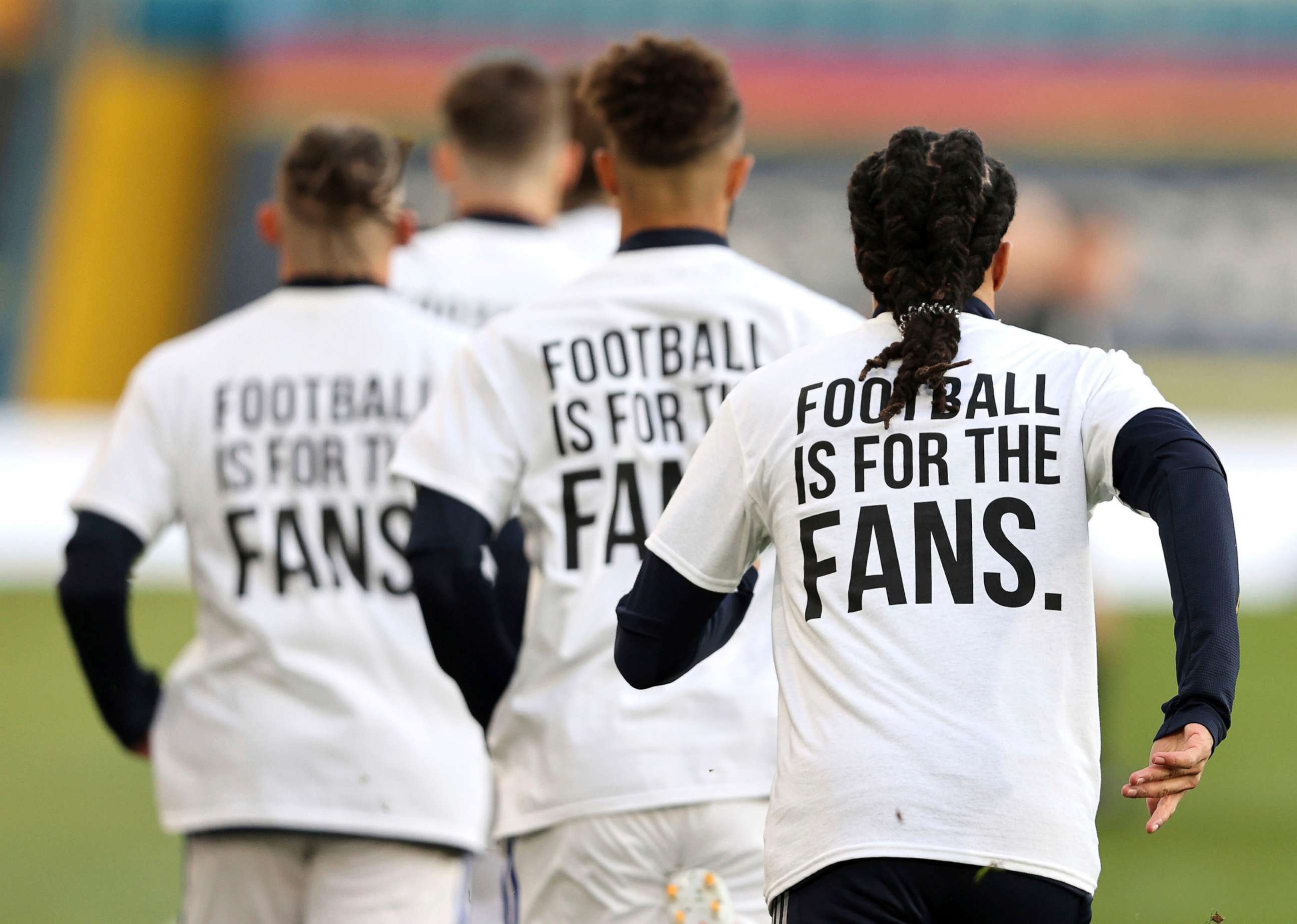 PHOTO: Leeds United players wear t-shirts with the logo 'Football Is For The Fans' as they warm-up ahead of ahead of the English Premier League soccer match between Leeds United and Liverpool at the Elland Road stadium in Leeds, England, April 19, 2021.