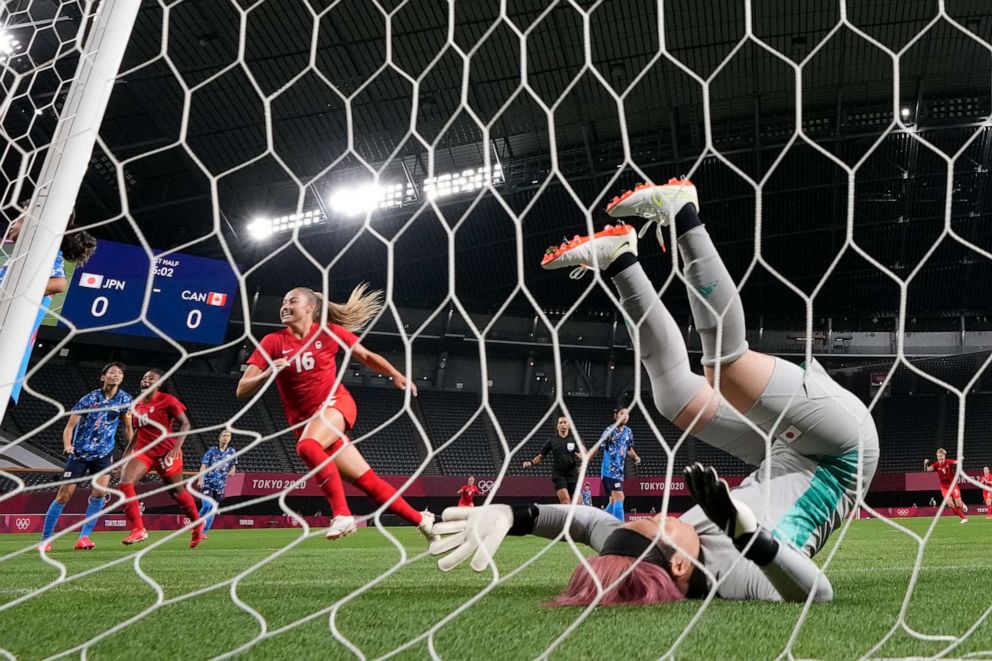 PHOTO: Japan's goalkeeper Sakiko Ikeda falls as Canada's players celebrate after Canada's Christine Sinclair scores a goal against Japan during a women's soccer match at the 2020 Summer Olympics, July 21, 2021, in Sapporo, Japan.