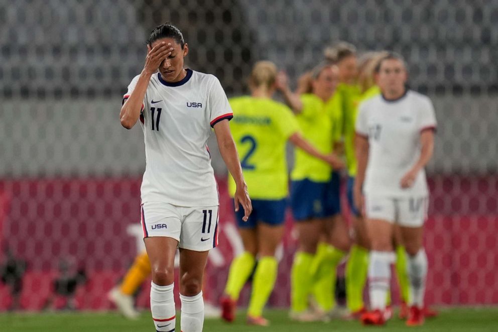 PHOTO: United States' Christen Press reacts as Sweden's players celebrate their third goal during a women's soccer match at the 2020 Summer Olympics, July 21, 2021, in Tokyo.