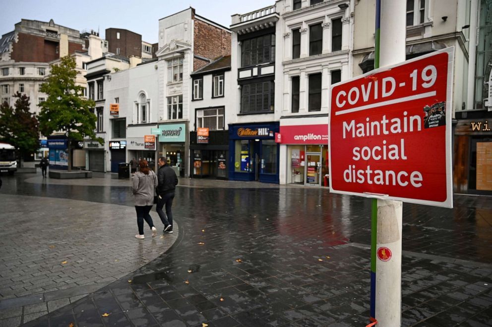 PHOTO: A street sign advises members of the public to "maintain social distance" in Liverpool, northwest England, on Oct. 12, 2020.