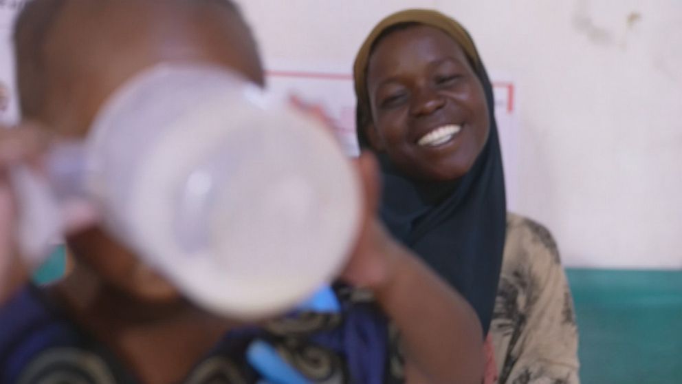 PHOTO: Garan Hassan smiles as her child Nadifa finally drinks at the hospital.